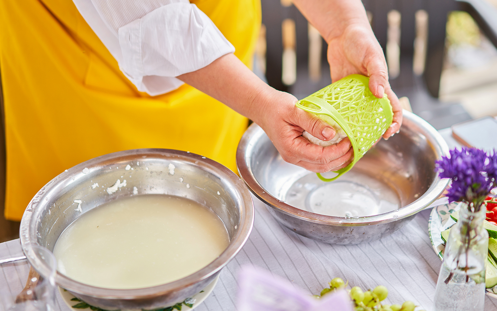 Swiss cheese-making demonstration in a traditional Swiss village setting.