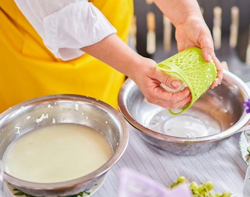 Swiss cheese-making demonstration in a traditional Swiss village setting.