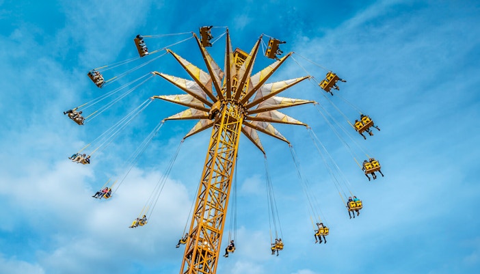 Parc Astérix swing ride with people enjoying the aerial view.