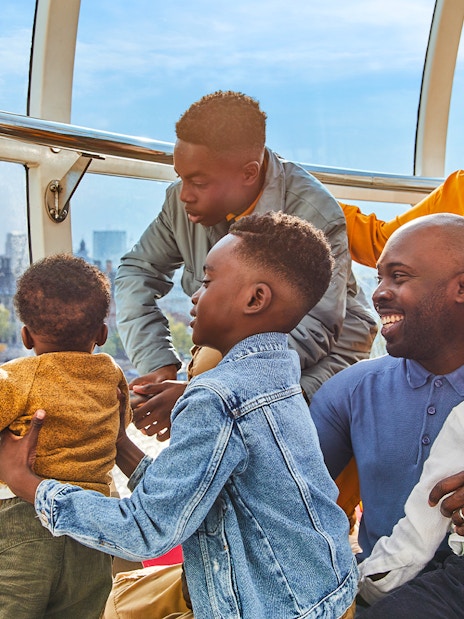 Family enjoying view of Big Ben from London Eye capsule.