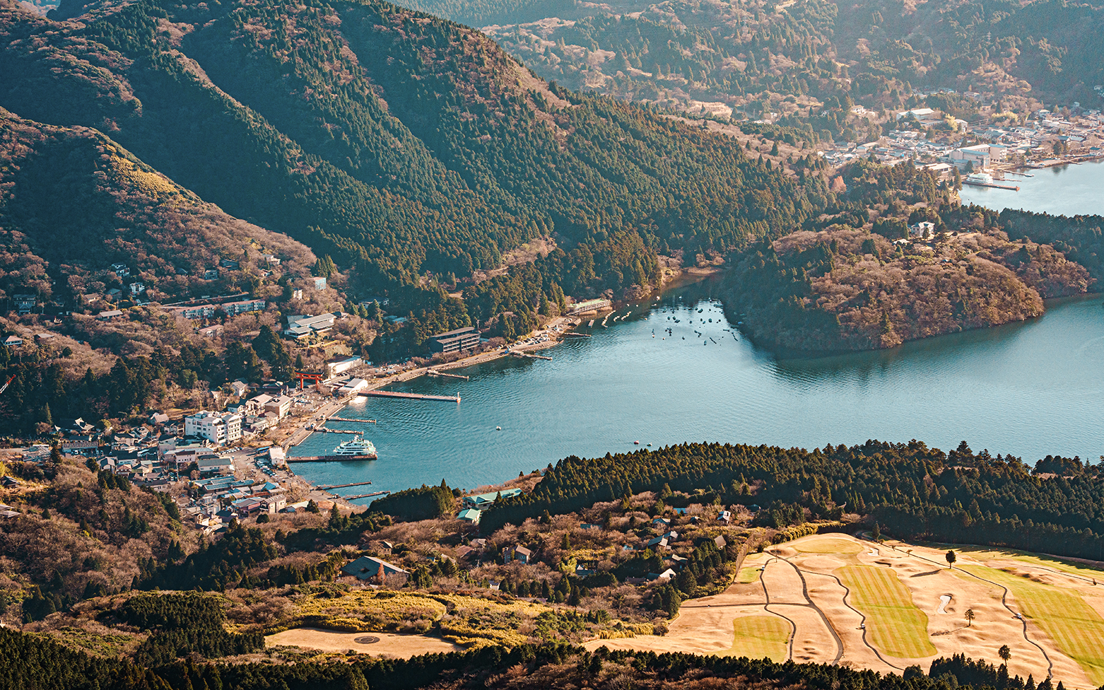 Aerial view of Lake Ashi and Hakone Mototsumiya area with surrounding mountains.