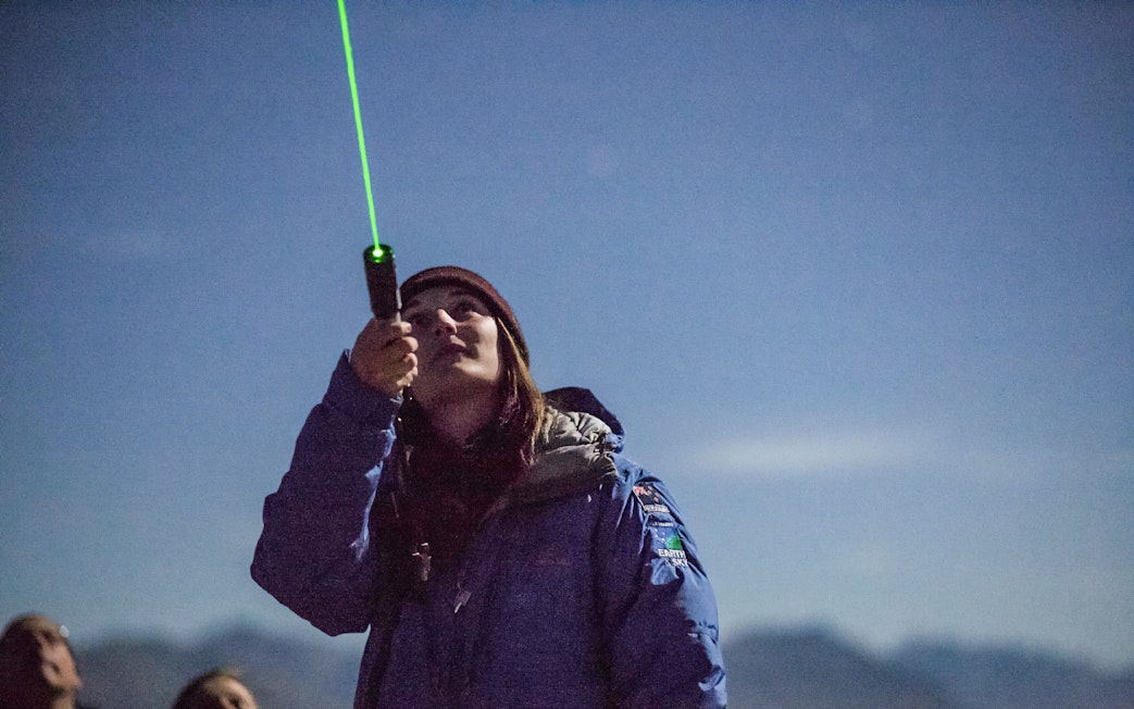 Guide using laser pointer at The Crater Stargazing Experience.