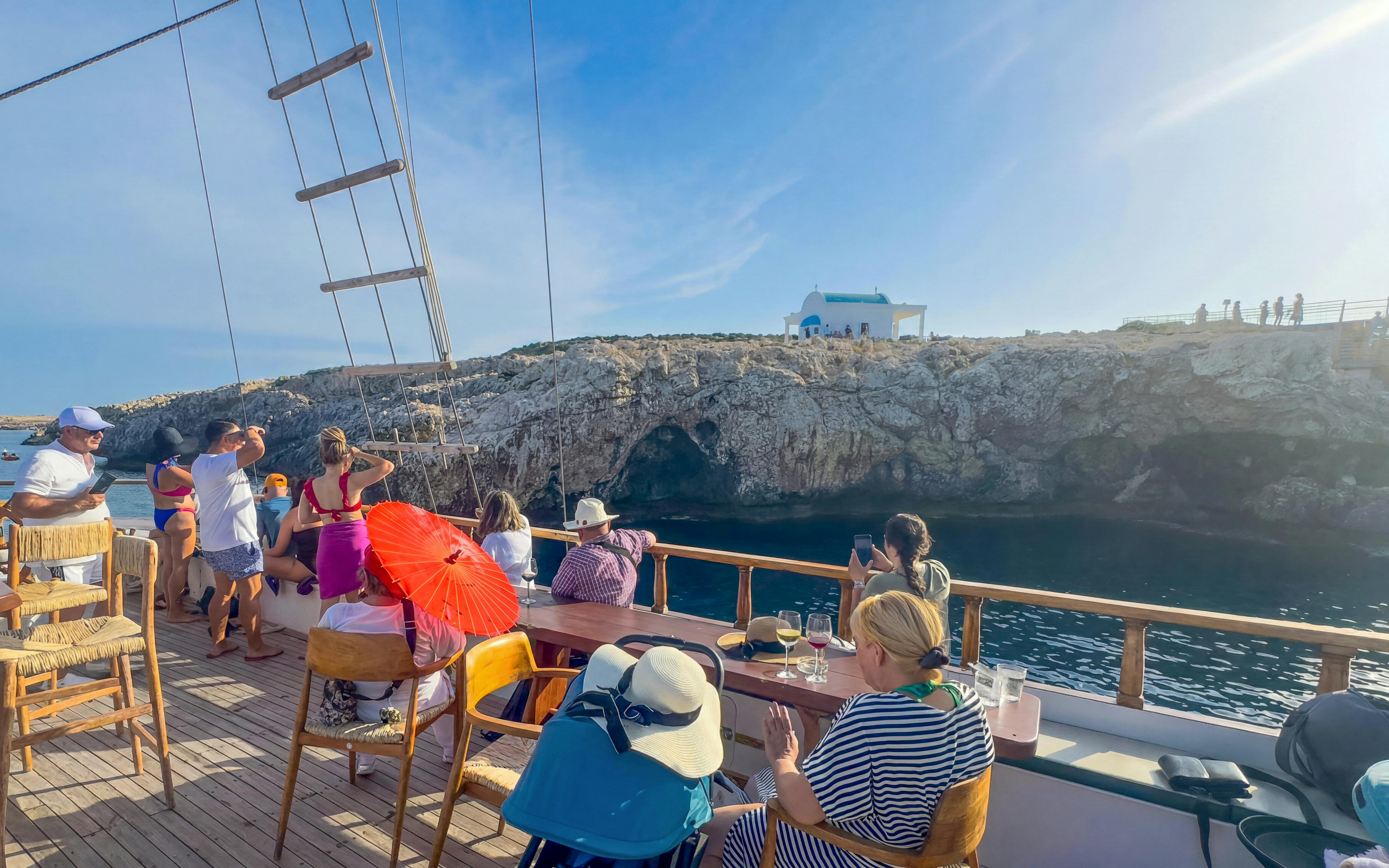 Boat tour near Blue Lagoon and caves in Protaras with passengers enjoying the view.