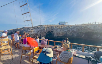 Boat tour near Blue Lagoon and caves in Protaras with passengers enjoying the view.