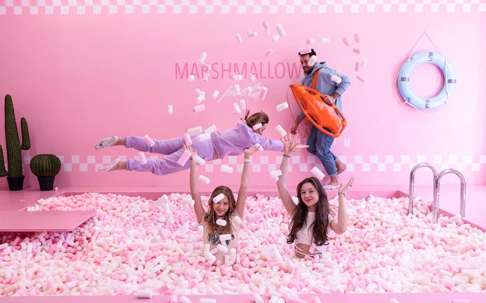 Tourists playing in marshmallow pool at Happy Museum, Warsaw.