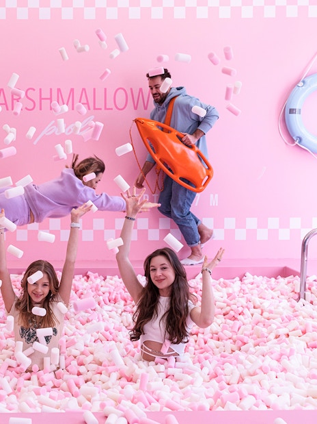 Tourists playing in marshmallow pool at Happy Museum, Warsaw.