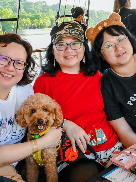 Three people and a dog on the Royal Albatross breakfast cruise.