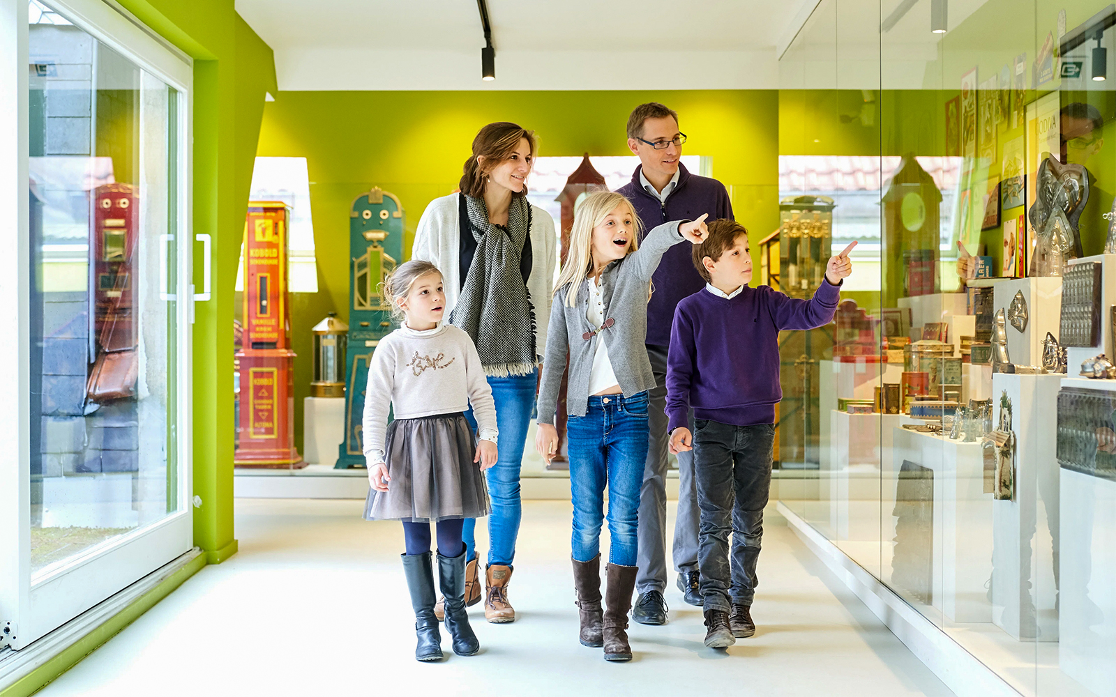 Family exploring exhibits at Choco Story Brussels museum.