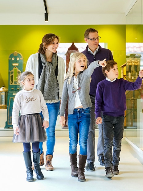 Family exploring exhibits at Choco Story Brussels museum.
