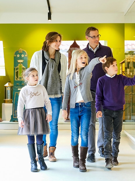 Family exploring exhibits at Choco Story Brussels museum.