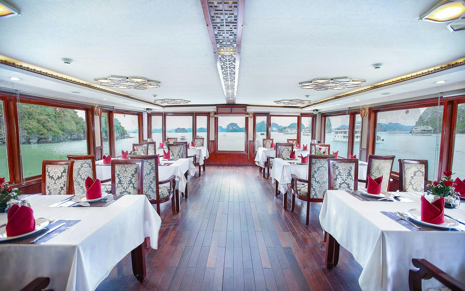 Dining area on a Halong Bay 3-star cruise with scenic views of limestone islands.