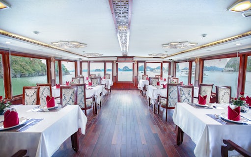 Dining area on a Halong Bay 3-star cruise with scenic views of limestone islands.