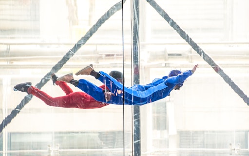Indoor skydiving at iFly Singapore with view of Sentosa Island.