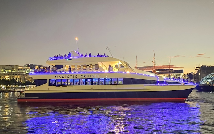 Cruise ship with blue lights on Sydney Harbour during Vivid Sydney festival.