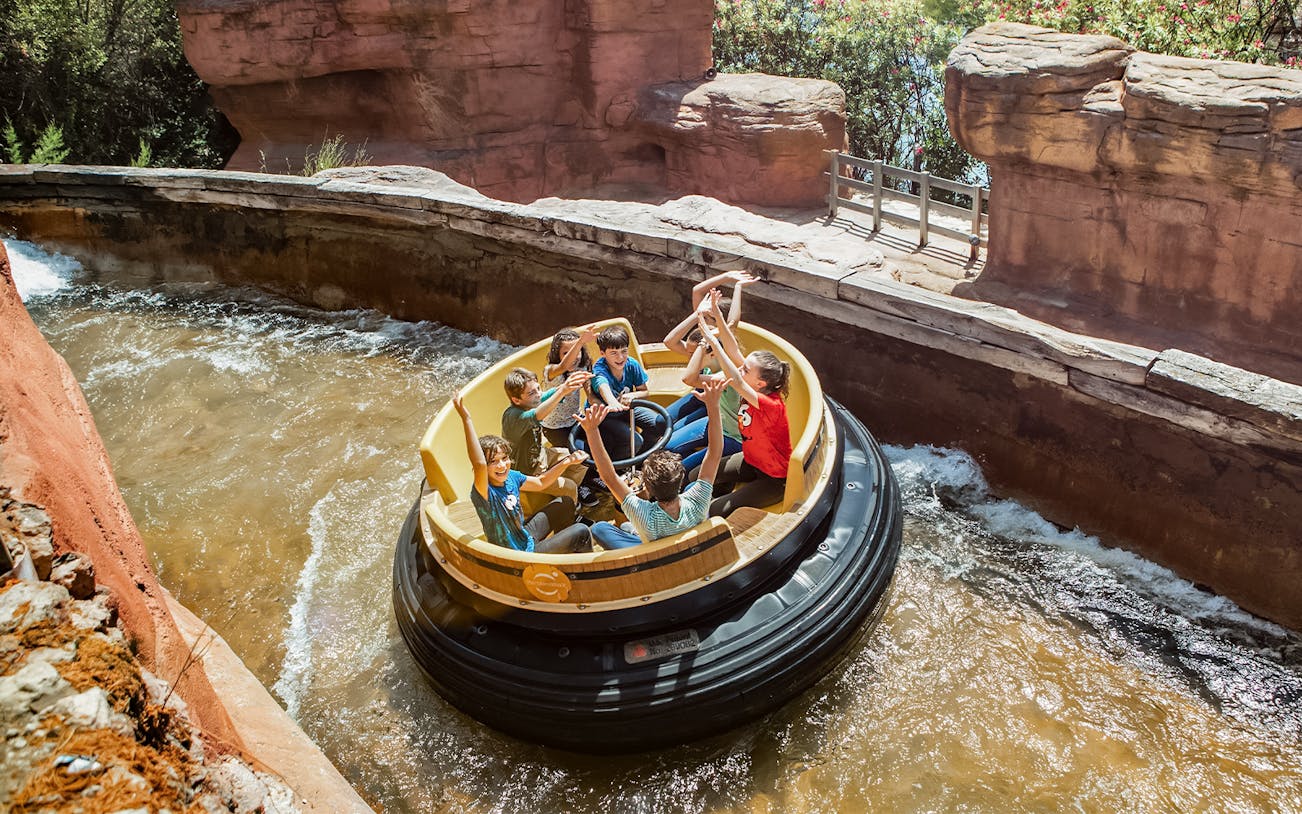 Raft ride with people enjoying water rapids at PortAventura.