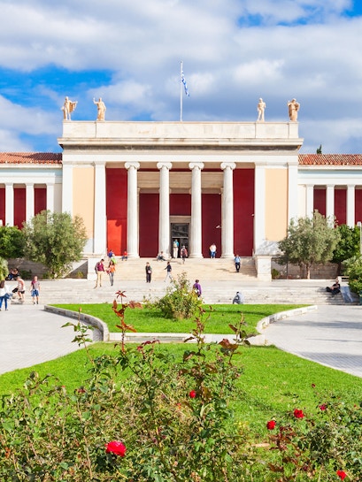 National Archaeological Museum entrance with columns and visitors in Athens, Greece.