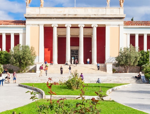 National Archaeological Museum entrance with columns and visitors in Athens, Greece.
