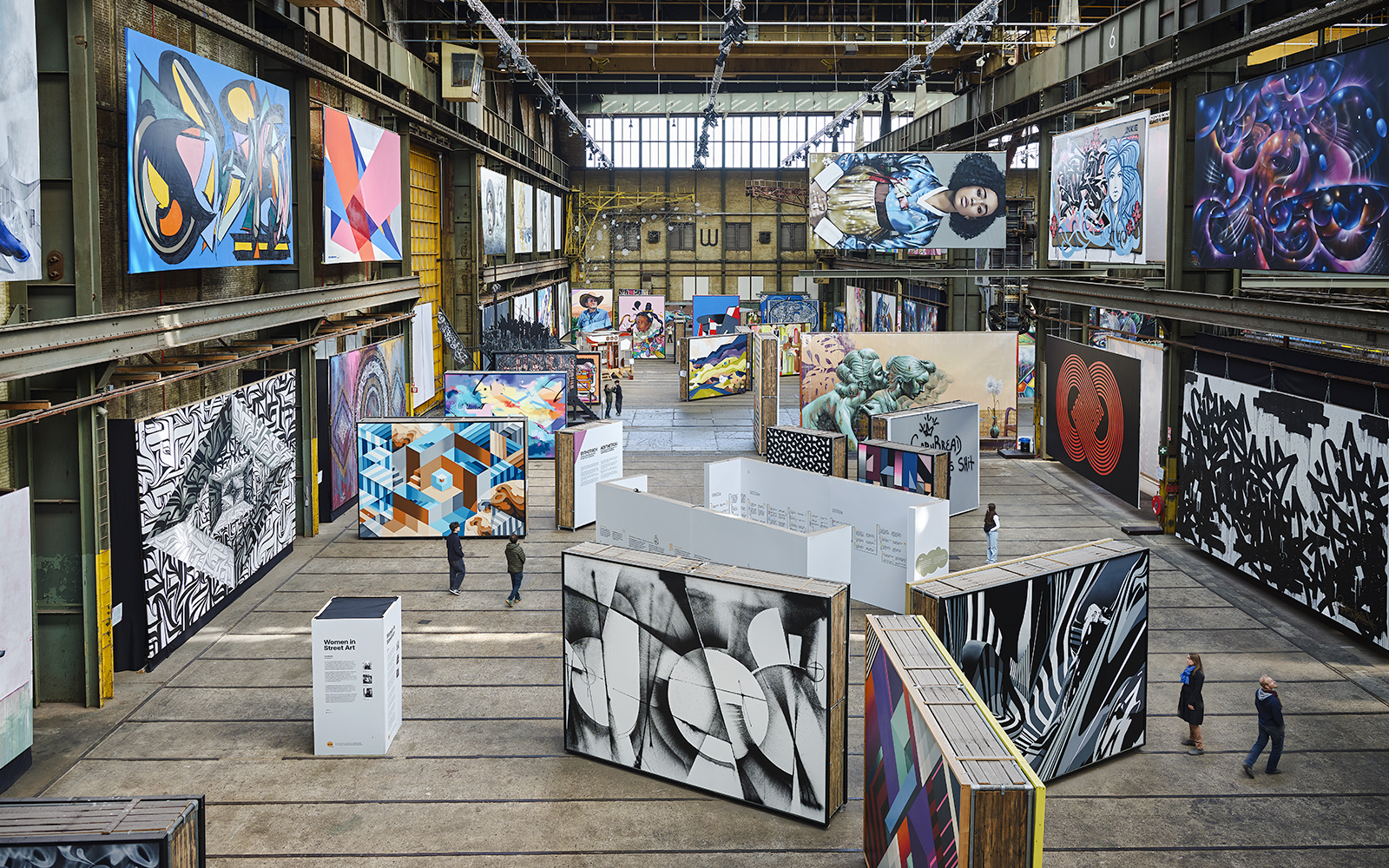 Straat Museum exhibits featuring diverse street art in an industrial setting.