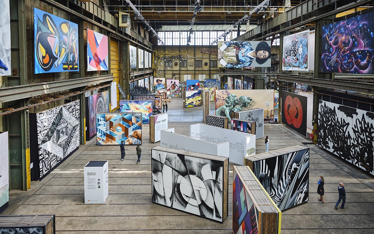 Straat Museum exhibits featuring diverse street art in an industrial setting.