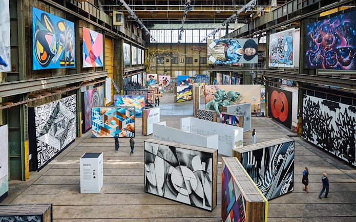 Straat Museum exhibits featuring diverse street art in an industrial setting.