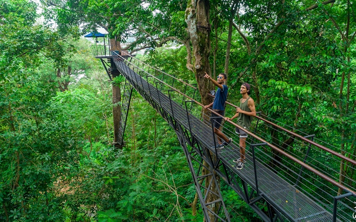 Men on a treetop walkway at Hanuman World, Phuket.
