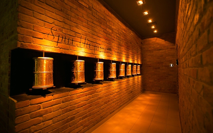 Prayer wheels in a dimly lit hallway at Mandala Day Spa.