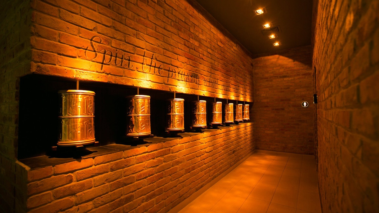 Prayer wheels in a dimly lit hallway at Mandala Day Spa.