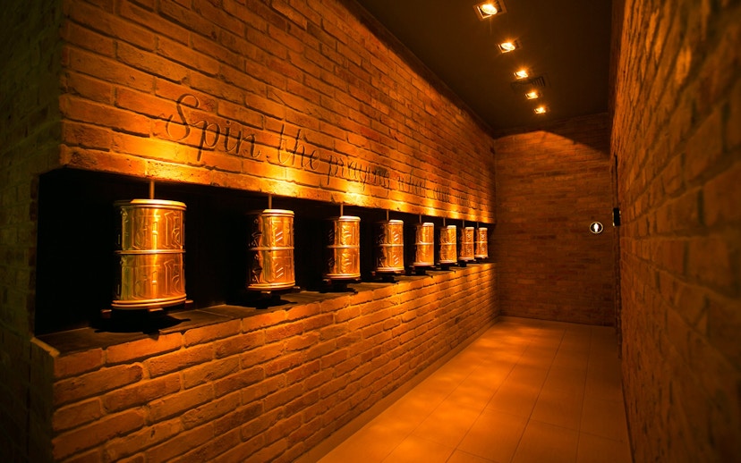 Prayer wheels in a dimly lit hallway at Mandala Day Spa.