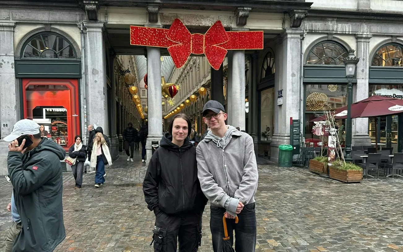 Brussels arcade entrance decorated for holiday season during city exploration game.