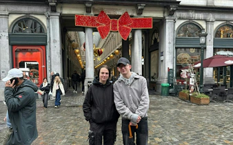 Brussels arcade entrance decorated for holiday season during city exploration game.