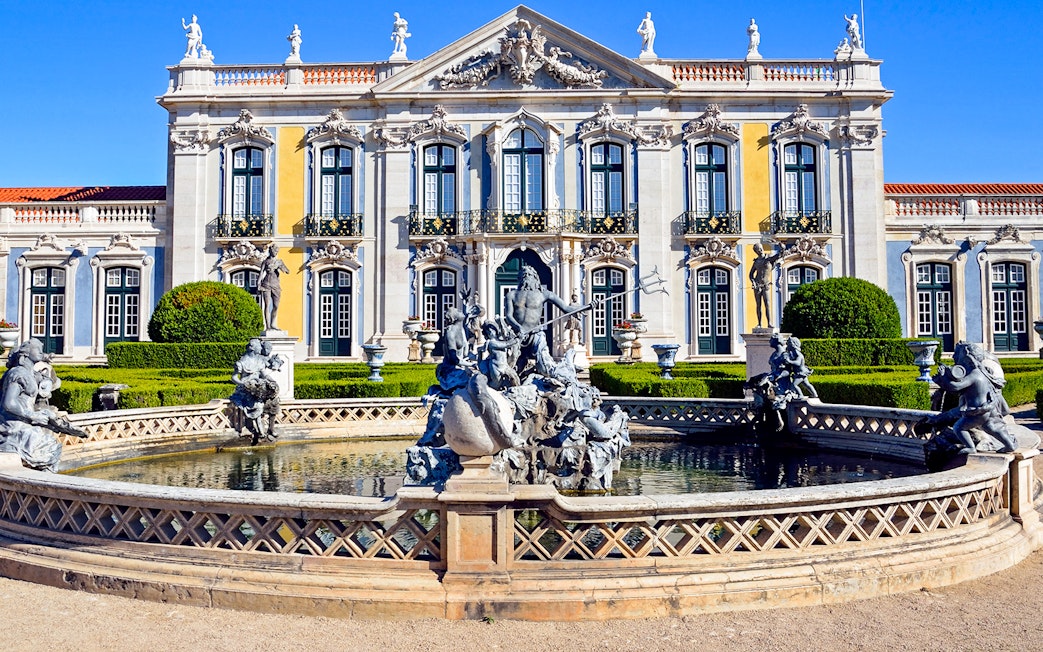 Neptune statue in garden fountain at Palace of Queluz, Portugal.