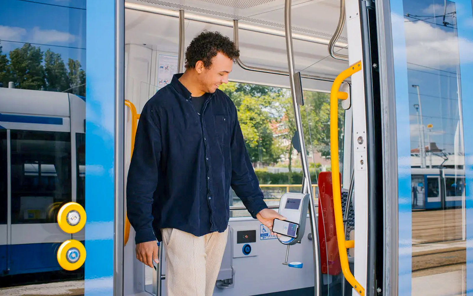Man using GVB multi-day ticket on Amsterdam tram.