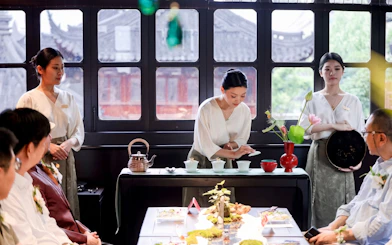 Tea ceremony at Huxinting Teahouse, Yu Garden, Shanghai with guests observing.