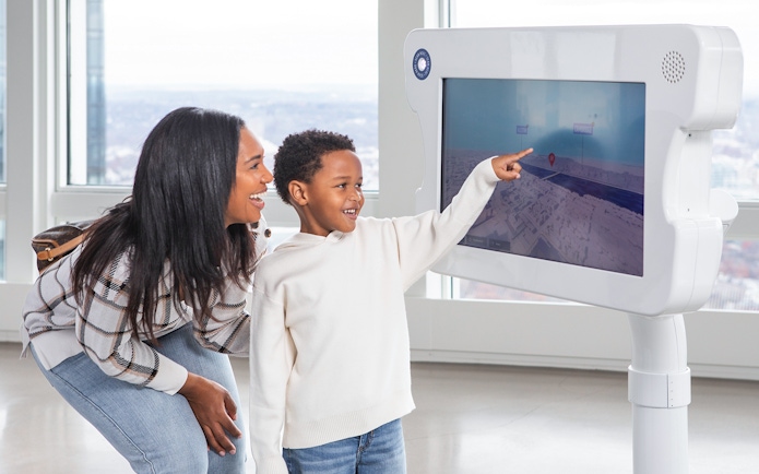 Mother and son using digital viewfinder at View Boston.