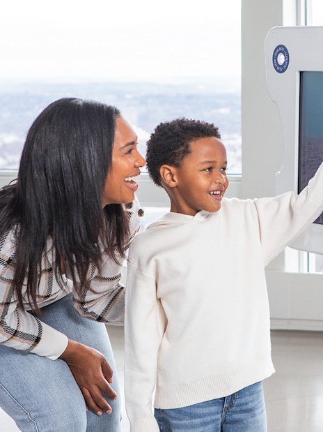 Mother and son using digital viewfinder at View Boston.
