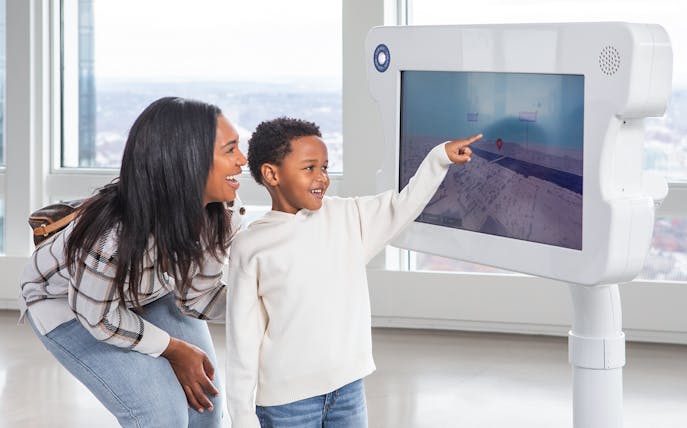 Mother and son using digital viewfinder at View Boston.