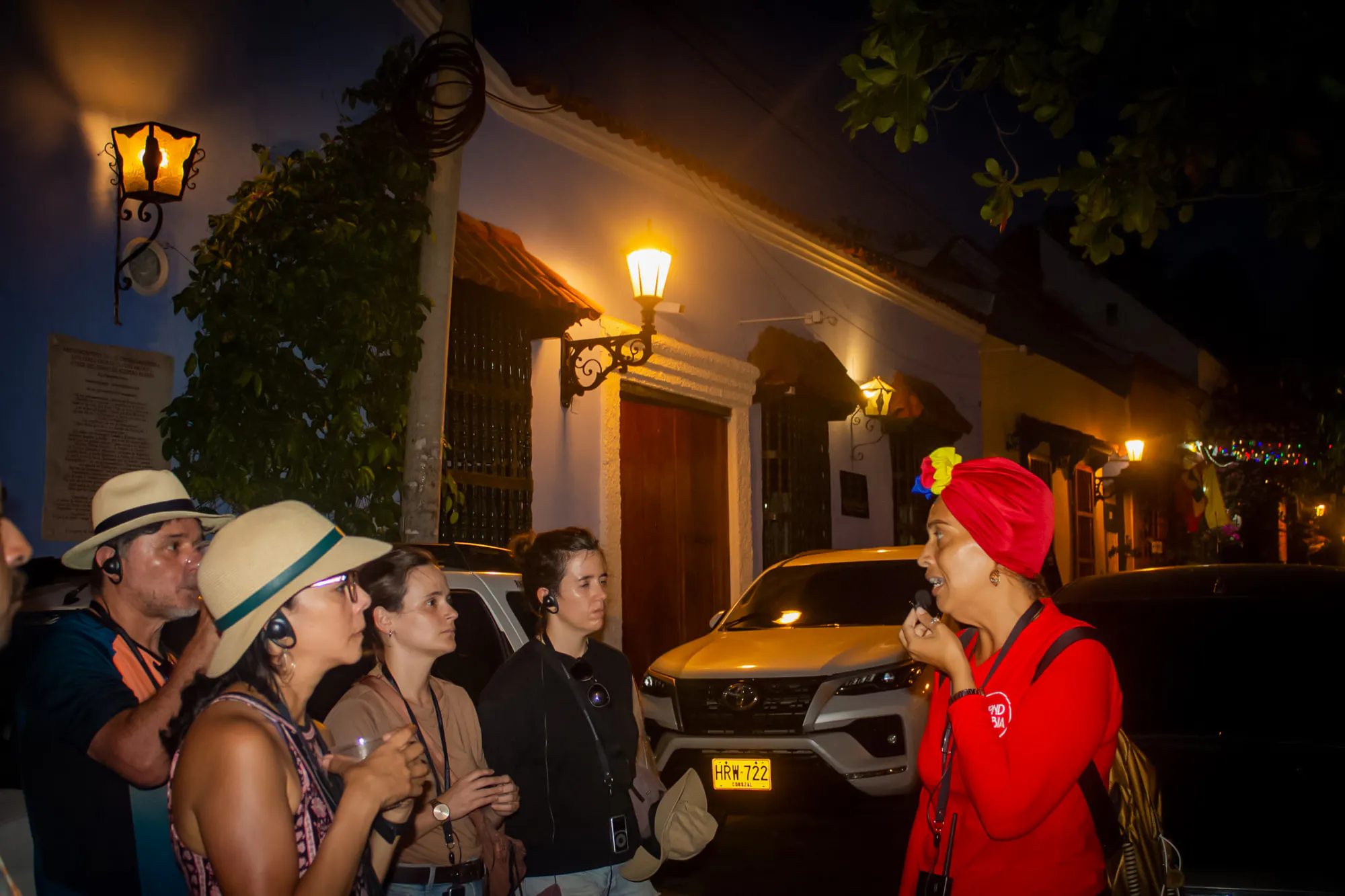 Tour guide speaking to a group at night in Cartagena's Walled Old City.
