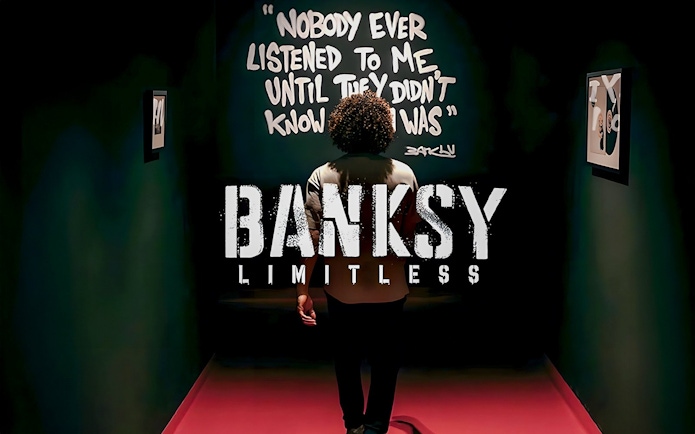 Visitor at Banksy Limitless exhibition viewing artwork with quote on wall.