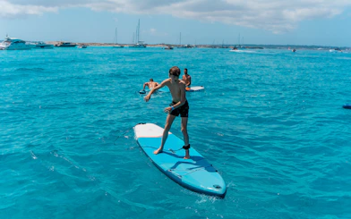 Paddleboarding on clear blue waters during Formentera Cruise Tour.