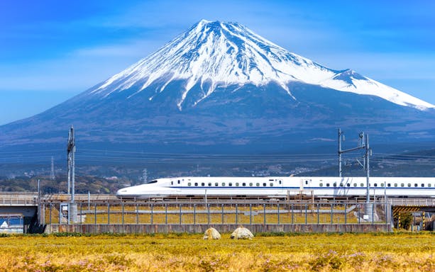 High-speed train passing Mount Fuji on JR Pass route, Tokyo.
