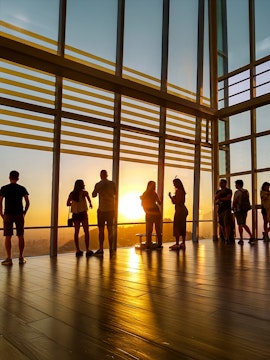 Visitors watching sunset from Sky Costanera observation deck, Santiago, Chile.