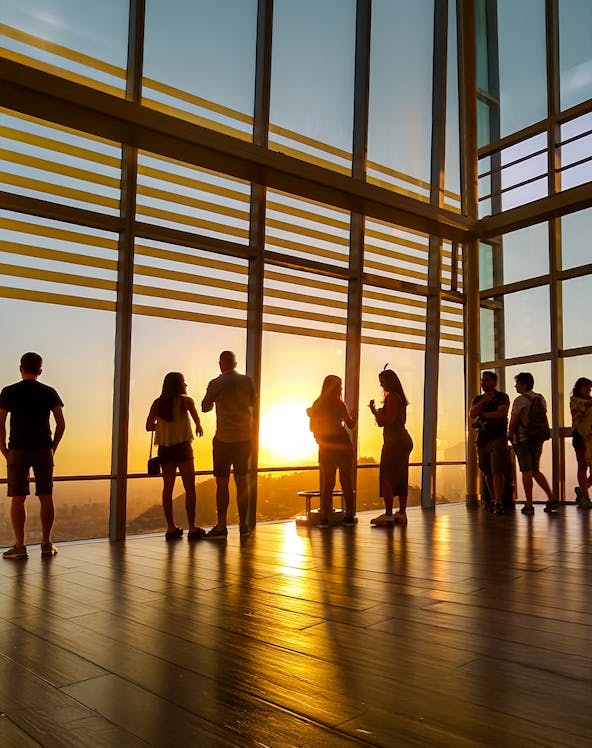 Visitors watching sunset from Sky Costanera observation deck, Santiago, Chile.