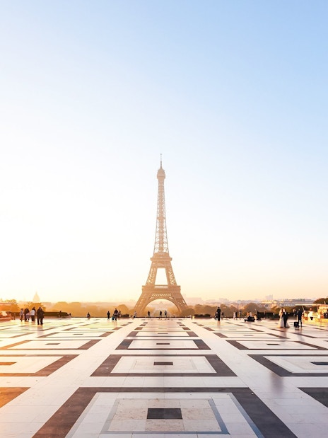 People on a guided Illumination Tour of Paris with Eiffel Tower at sunset.
