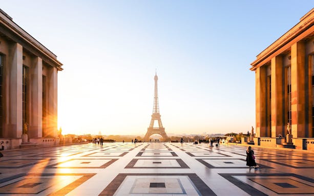 People on a guided Illumination Tour of Paris with Eiffel Tower at sunset.