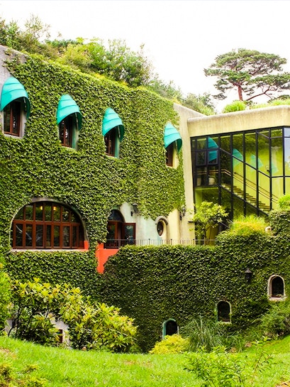 Studio Ghibli Museum exterior with ivy-covered walls and arched windows in Mitaka, Japan.