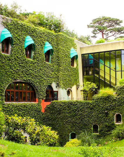 Studio Ghibli Museum exterior with ivy-covered walls and arched windows in Mitaka, Japan.