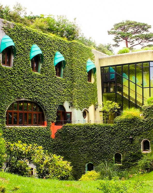 Studio Ghibli Museum exterior with ivy-covered walls and arched windows in Mitaka, Japan.