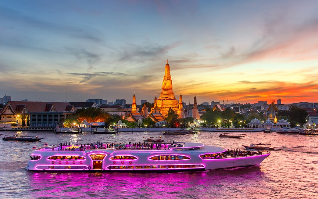 Chao Phraya Princess Cruise passing Wat Arun at sunset, Bangkok.