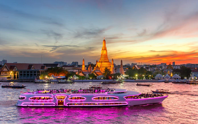 Chao Phraya Princess Cruise passing Wat Arun at sunset, Bangkok.