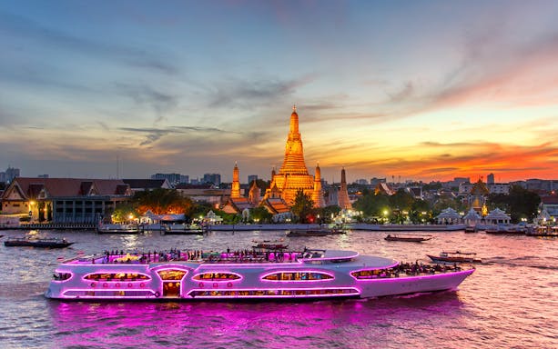 Chao Phraya Princess Cruise passing Wat Arun at sunset, Bangkok.